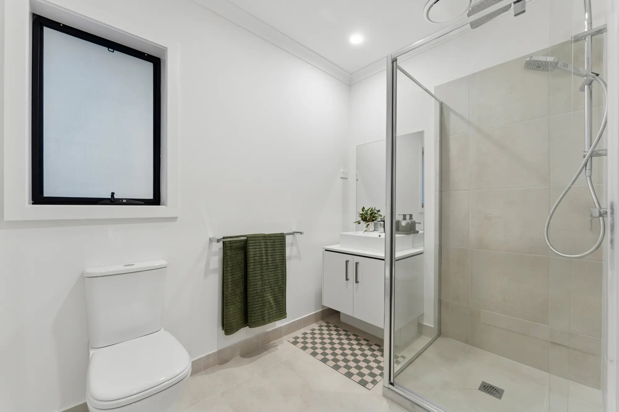 Bathroom with shower, vanity and toilet