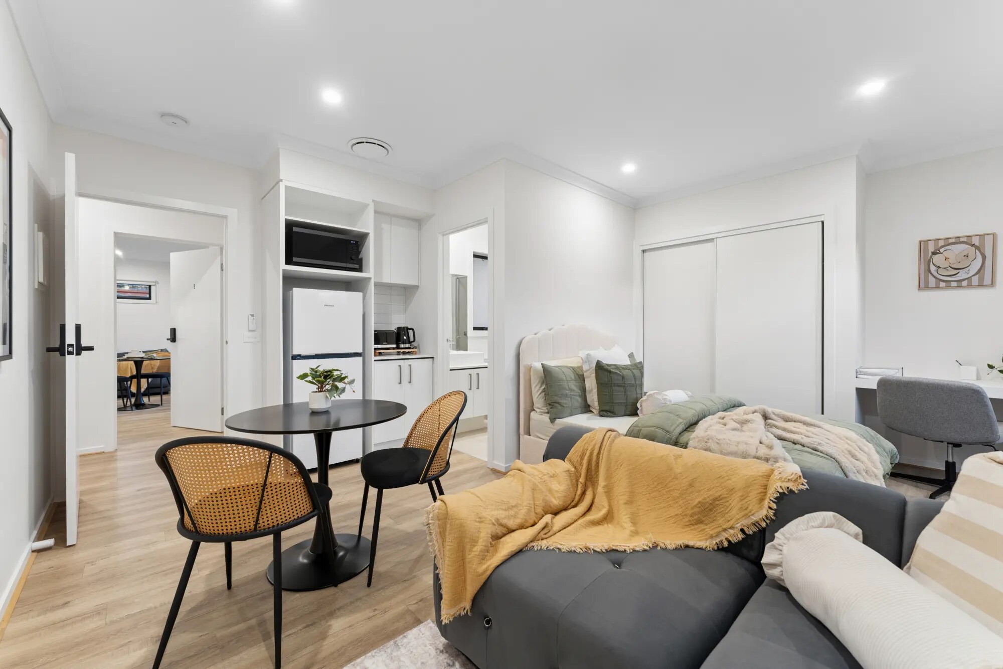 Private suite with kitchenette bench and furnished living area