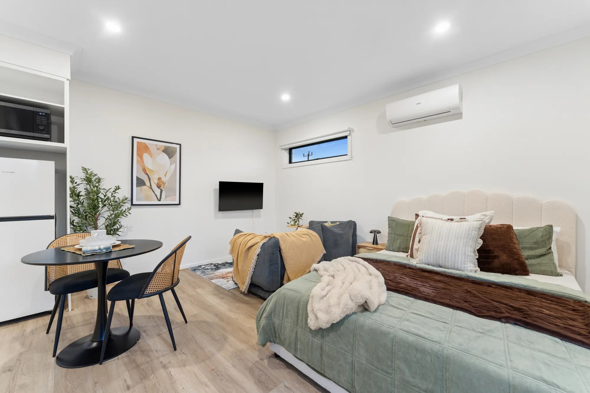 Example furnished private suite with bed, table and sitting area
